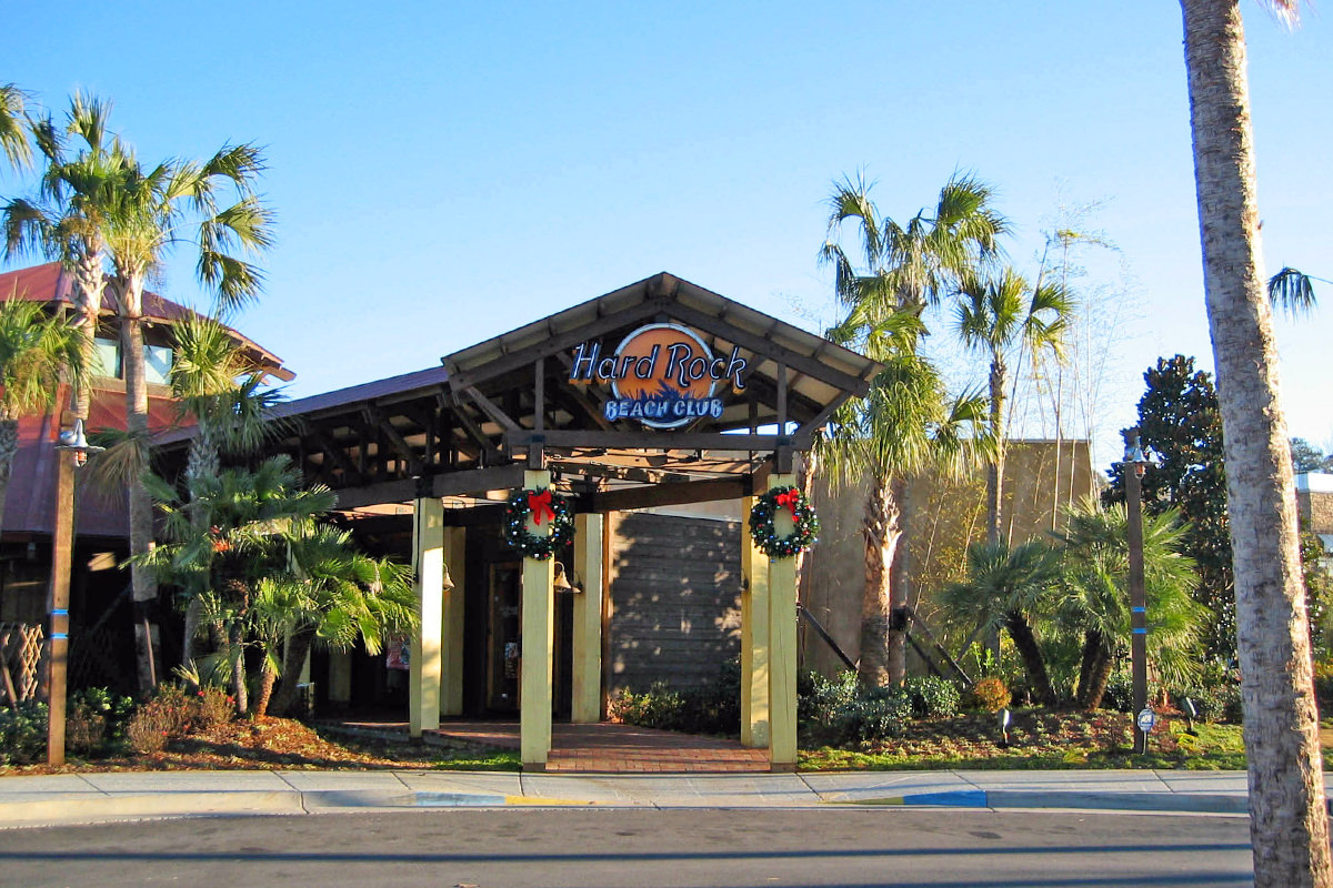 The Hard Rock Beach Club Choctaw, with open-air architecture and Christmas wreathes on the posts before the entry.