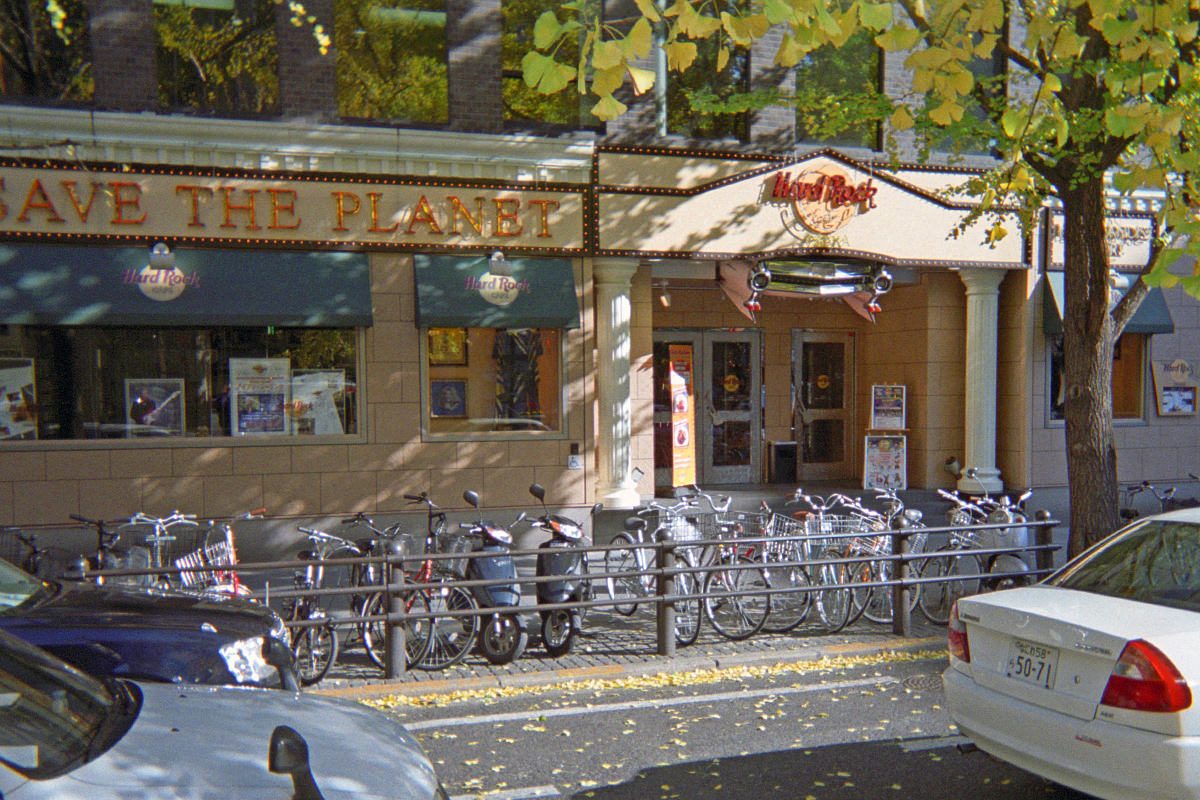 The exterior of the Hard Rock Cafe Osaka with many, many bikes parked out in front of it.