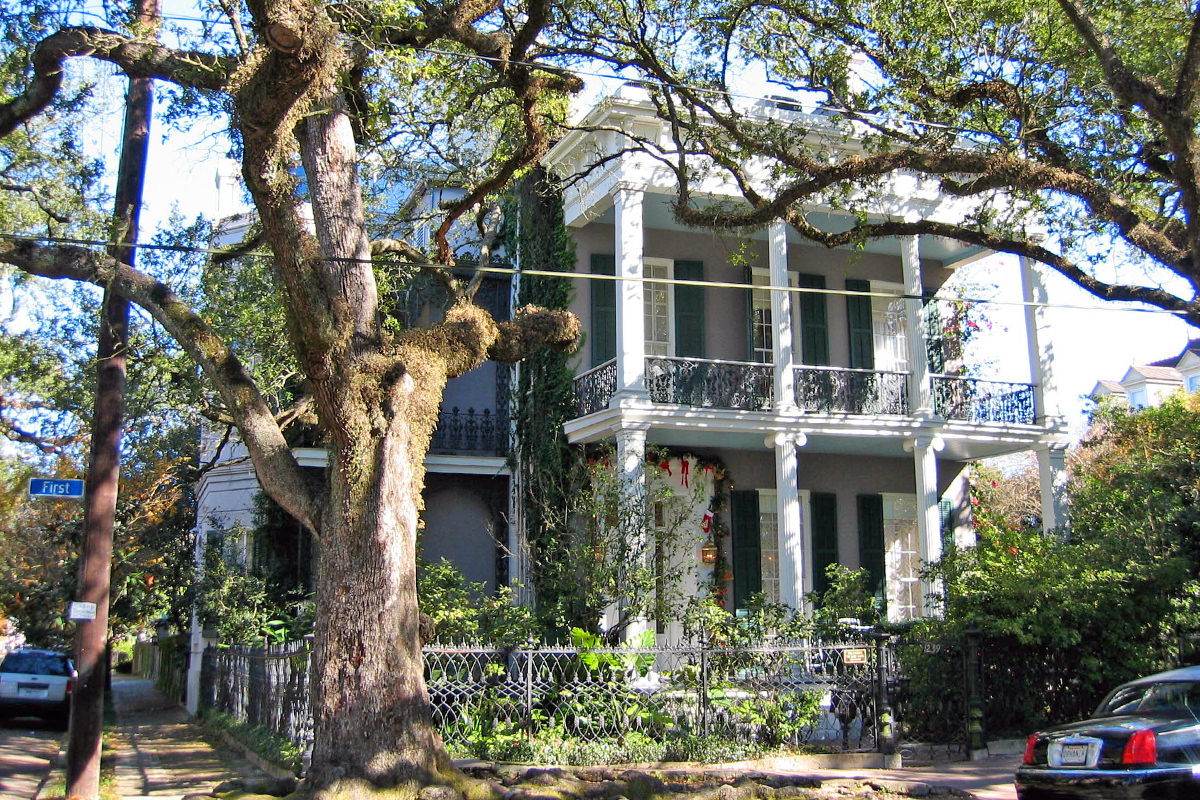 Anne Rice's lovely gray two-story home with iron fencing accents.