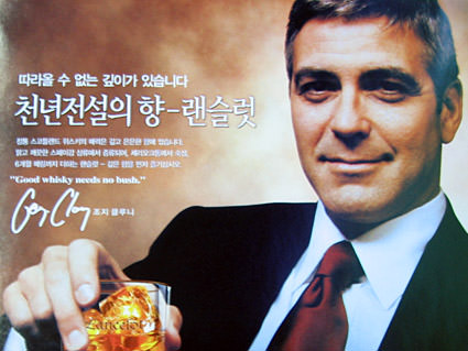 An ad with George Clooney holding a glass of whiskey.