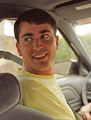 Dave as a totally hot young man looking back while driving a car.