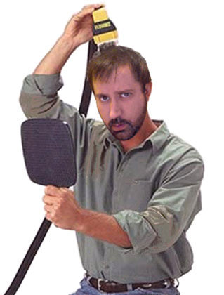 Dave Photoshopped to be using a Flowbee hair cutter.