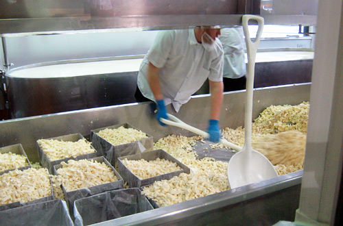 A guy making cheese at Beechers Cheese