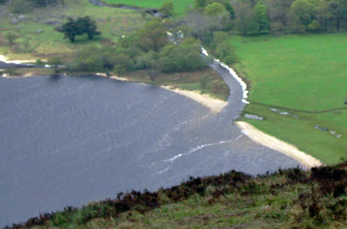 A photo of Lough Tay's white sand beach.