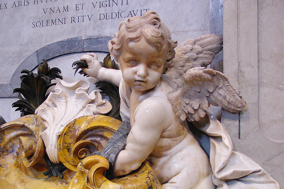 A cherub statue affixed to a wall of St. Peter's in The Vatican.
