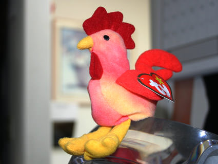 Strut McChicken, a stuffed Beanie Baby rooster sitting on top of my Macintosh G4 desktop computer.