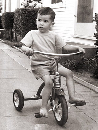 Me when I was very young riding a tricycle.