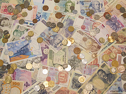 A photo of a bunch of foreign currency scattered on a table.