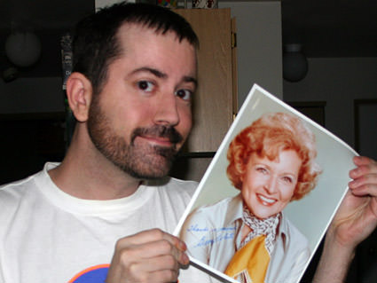 Me holding an autographed photo of Betty White.