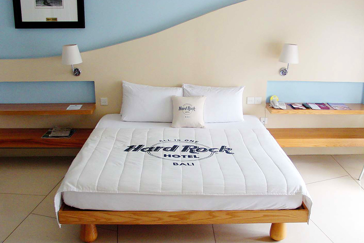 My Bed at the Hard Rock Hotel in Bali which has a giant Hard Rock Hotel logo on it.