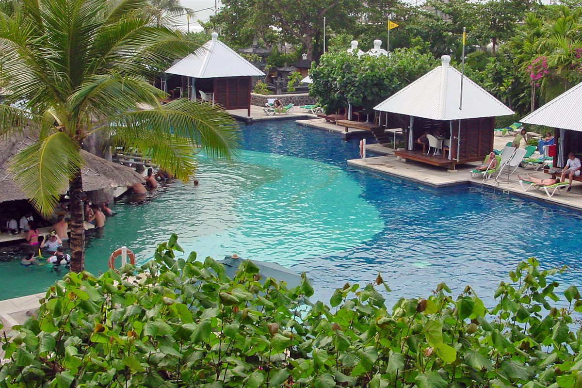 Looking down at some cabanas next to a brilliant blue pool at the Hard Rock Hotel in Bali.