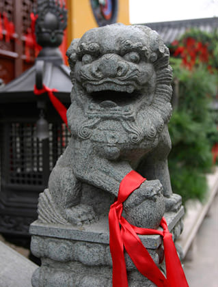 Red Ribbon on a Stone Lion