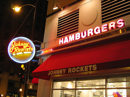 Johnny Rockets restaurant on Rush Street in Chicago at night.