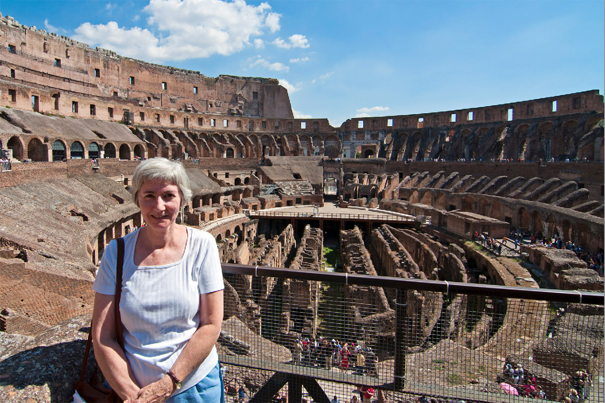 Travels with Mom who is standing at the Colosseum in Rome.