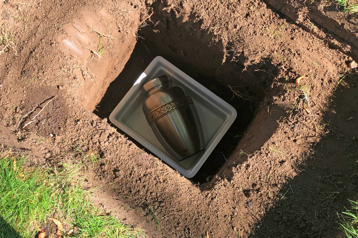 Mom's urn in the plastic chamber in her gravesite.