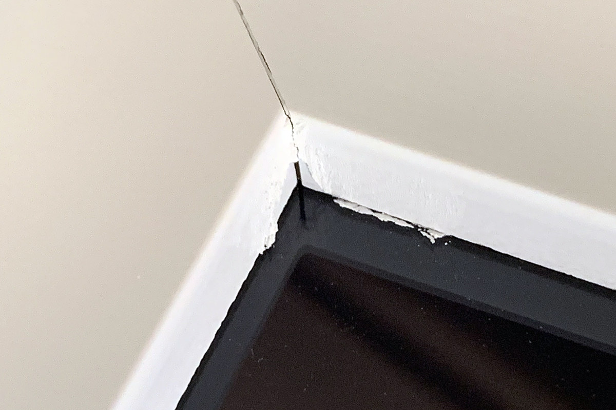 A close up of the crappy $60 fram showing that the paint is bubled and peeling in the corners.