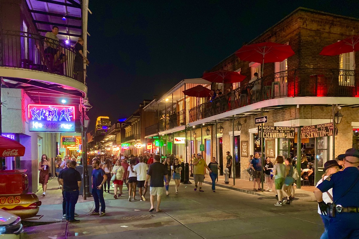 The madness of Bourbon Street at night... people acting crazy and having fun under the neon lights from the signage.