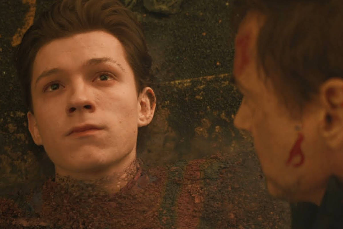 Spider-Man fades away to dust while Tony Stark watches from Avengers: Endgame.