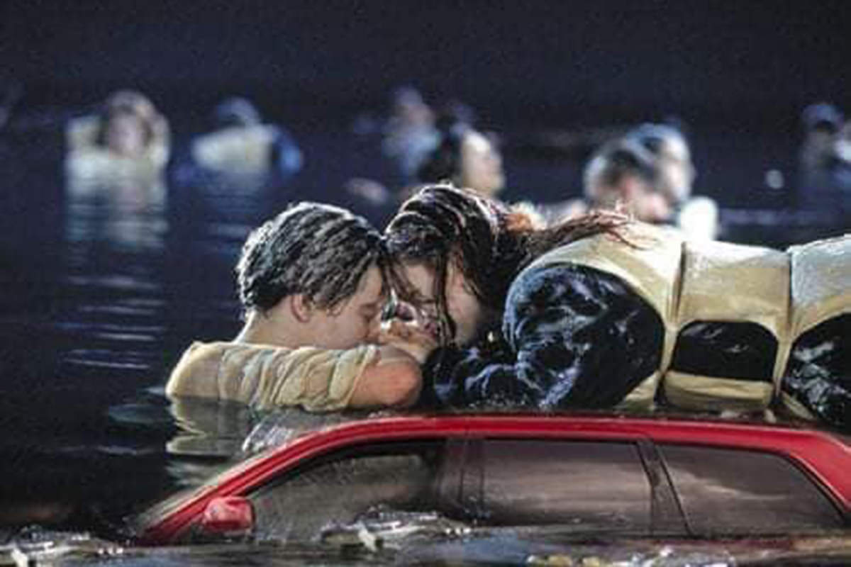 Rose and Jack from Titanic on top of the beached car which is now sinking into the North Atlantic Ocean.