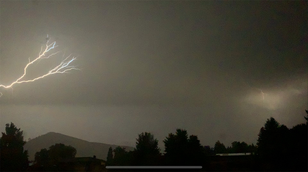 Lightning striking a nearby hillside.