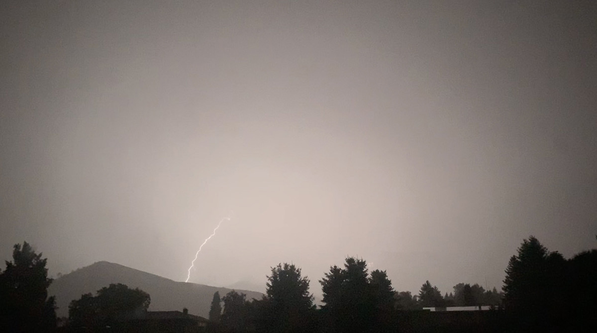 Lightning striking a nearby hillside.