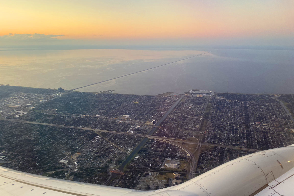 Looking out an airplane window at the bridge which spans Lake Pontchartrain.