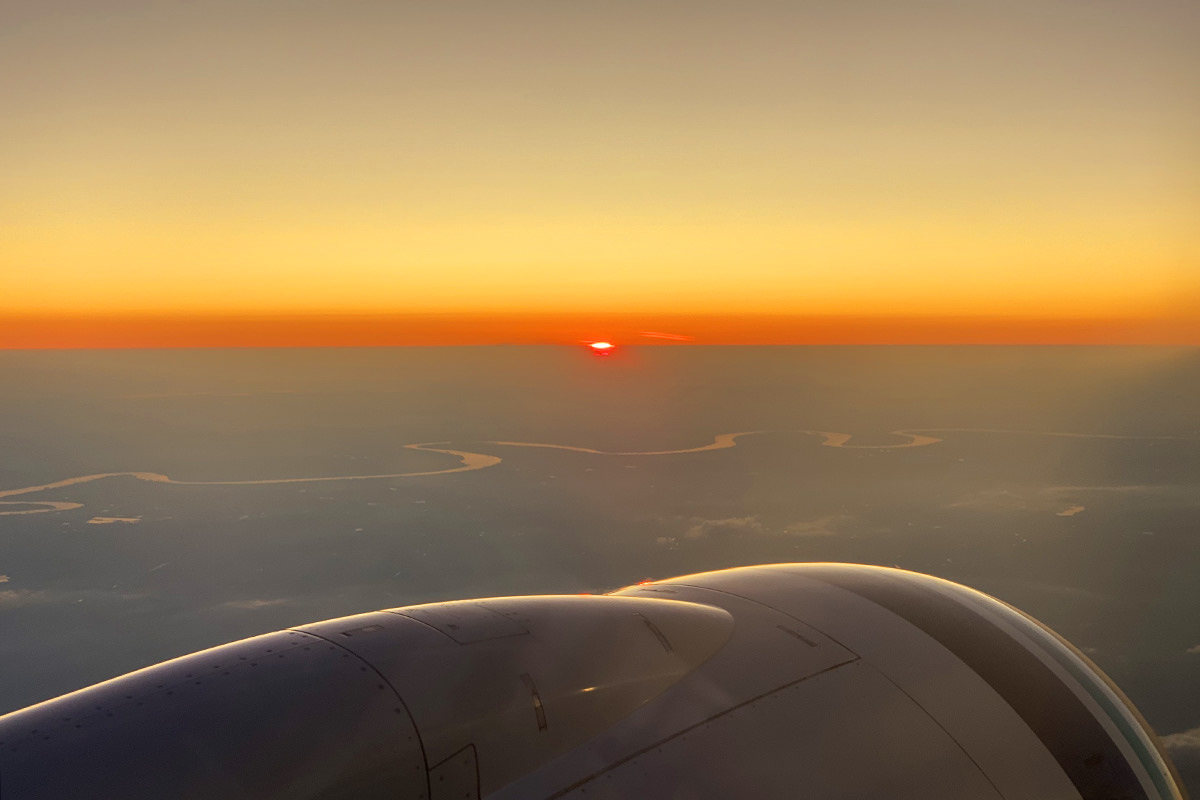 A pretty sunset in reds, yellows, and oranges out my plane window.