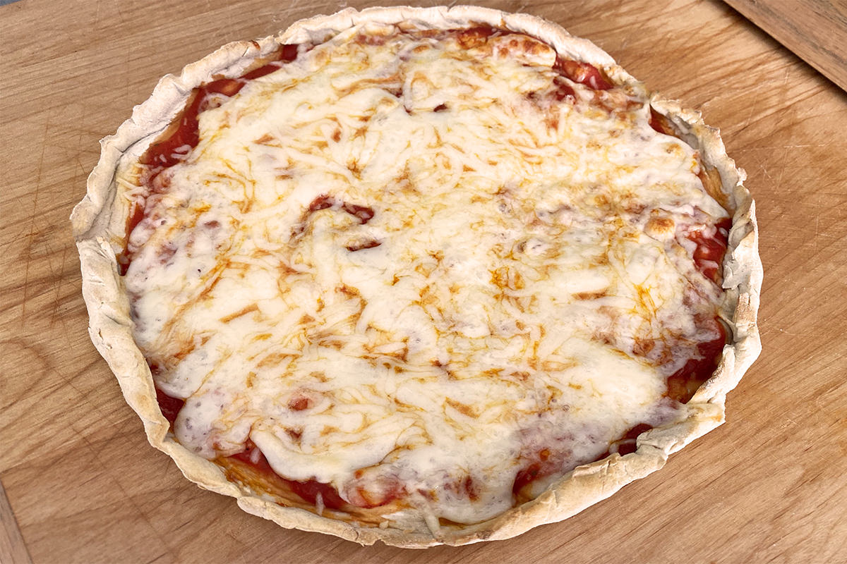 My perfect pizza, sitting on a cutting board.