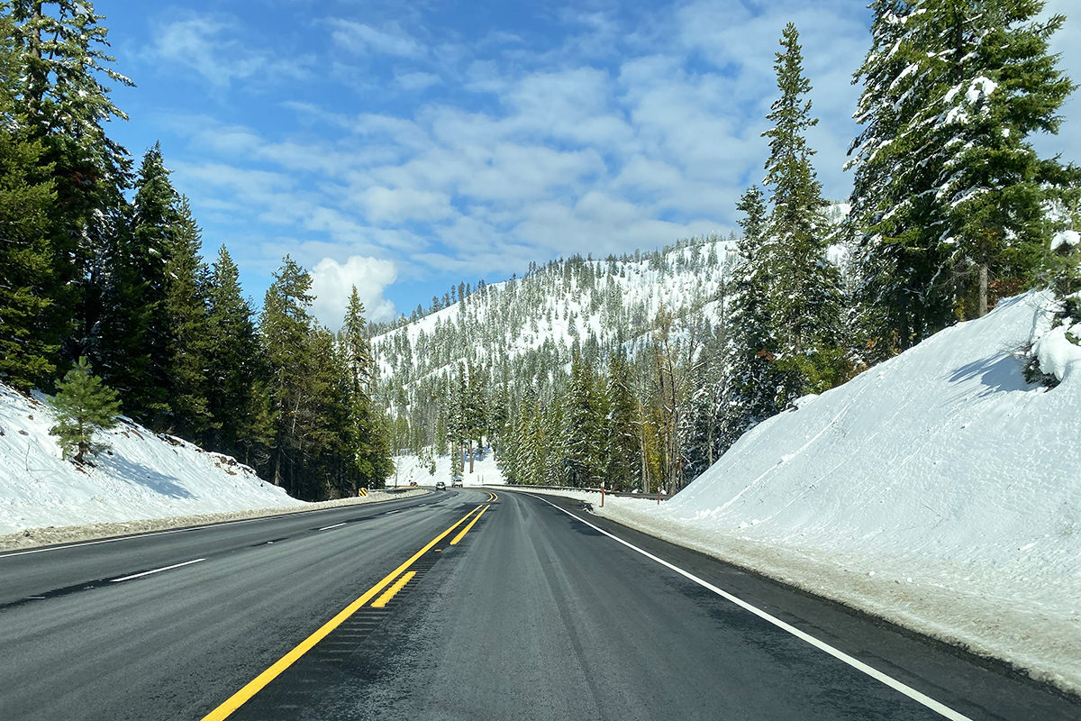 Driving home with sunny skies and snowy scenery.