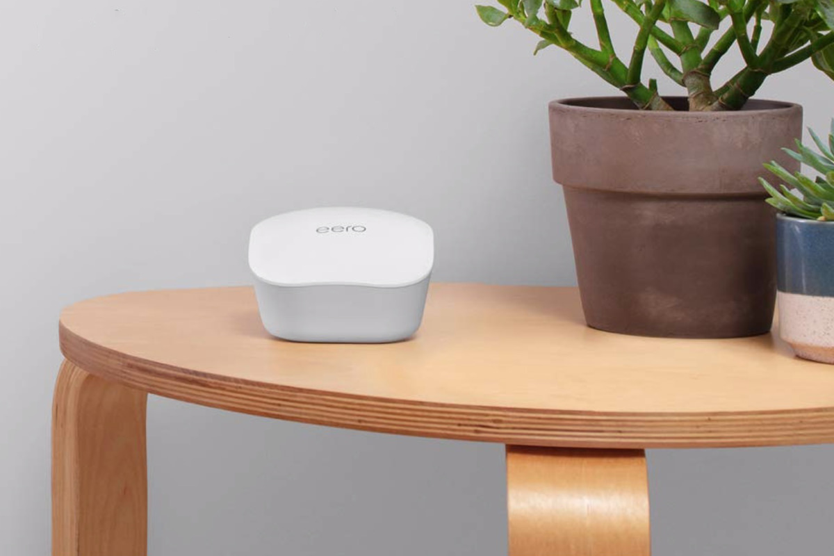 An eero mesh router pod sitting on a desk and looking like shit.