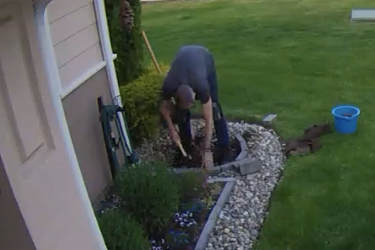 Me digging in the dirt of my front flower bed.