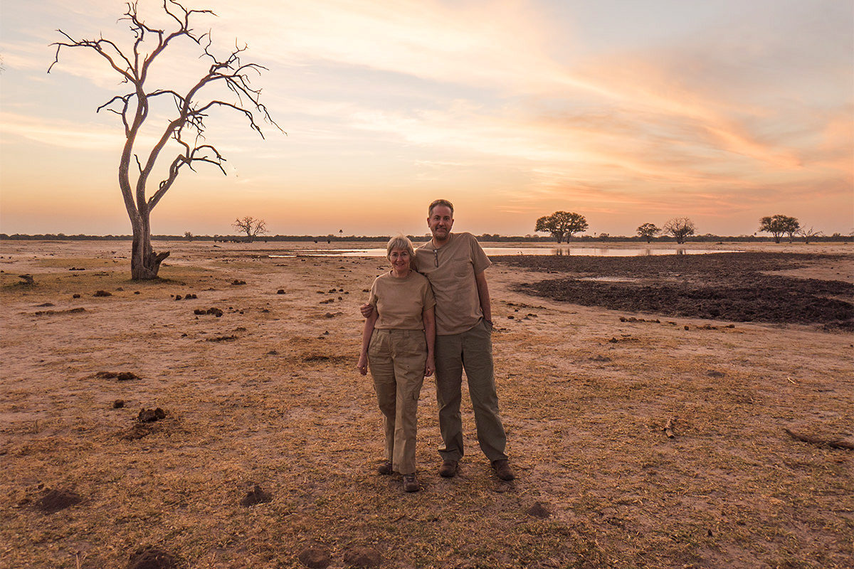 Mom and I standing under a gorgeous African sunset with the savannah in the background.