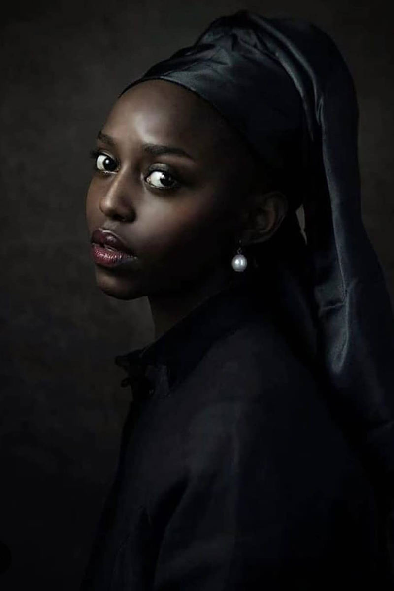 A Black woman reinacting the famous Vermeer painting Girl with a Pearl Earring.