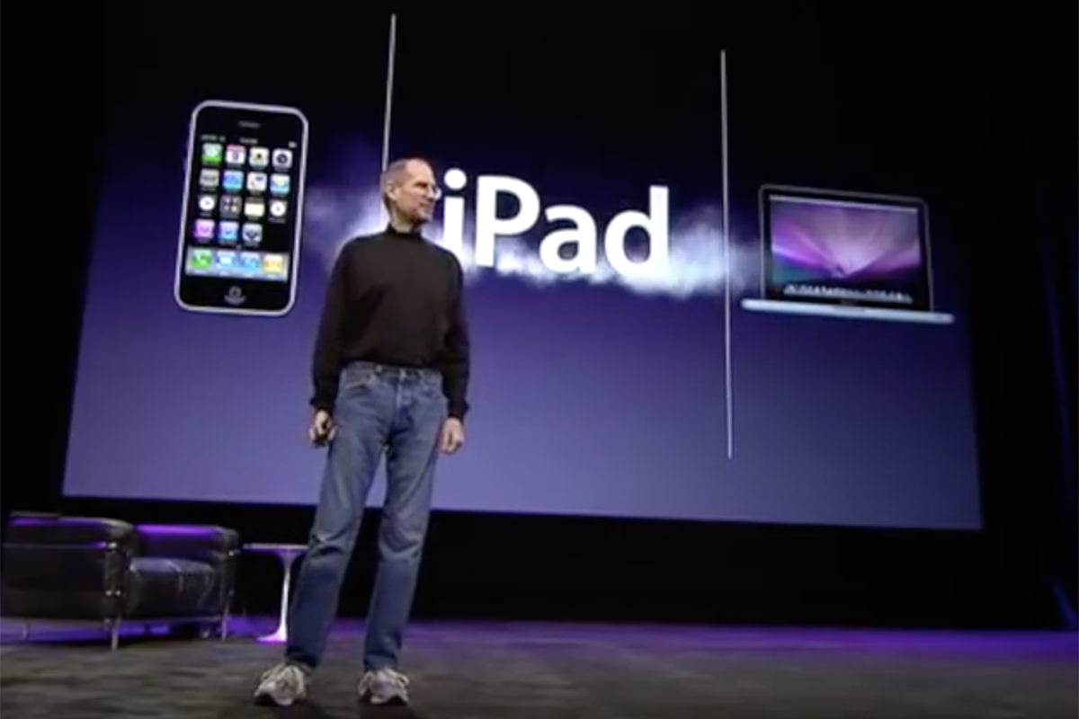 Steve Jobs unveiling the iPad at a computer event.