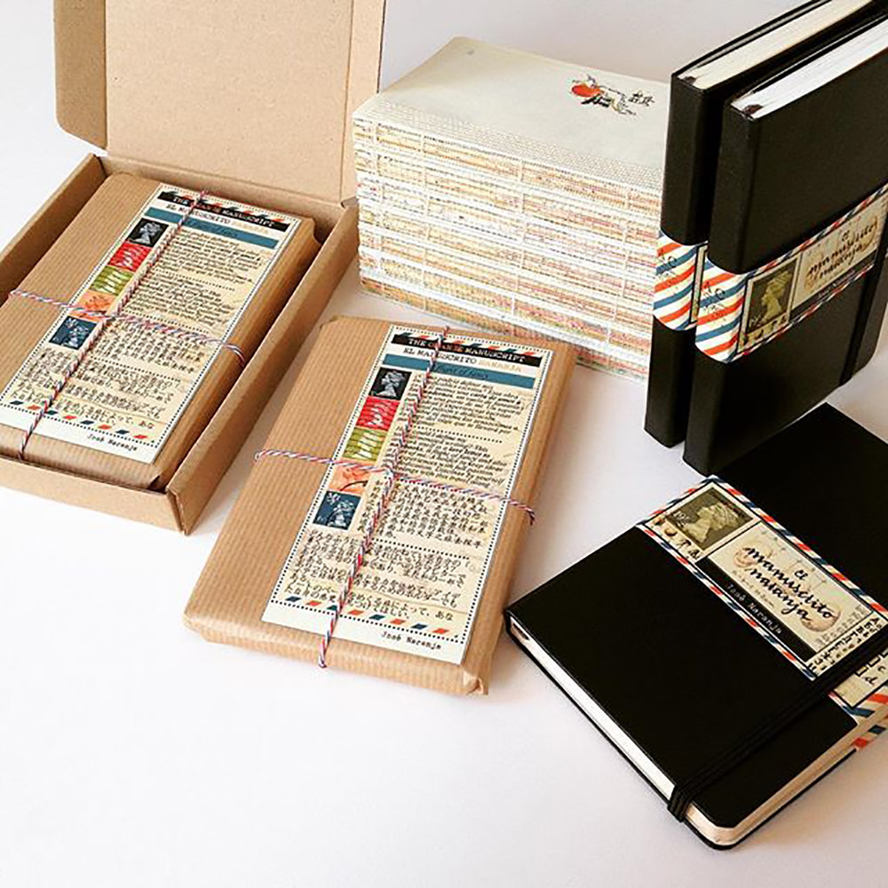 A photo of José Naranja journals with thick black covers and beautiful packaging.