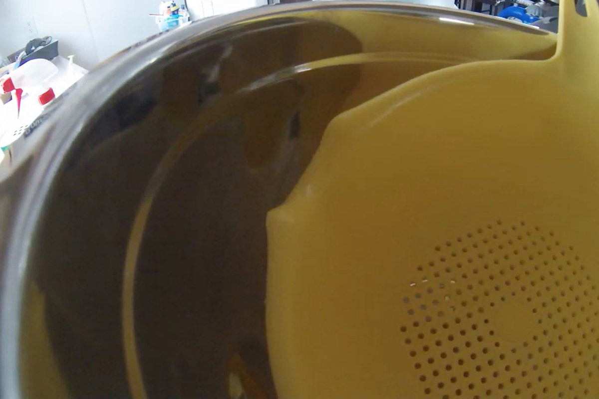 A stack of dishes completely obstructing the kitchen security camera.