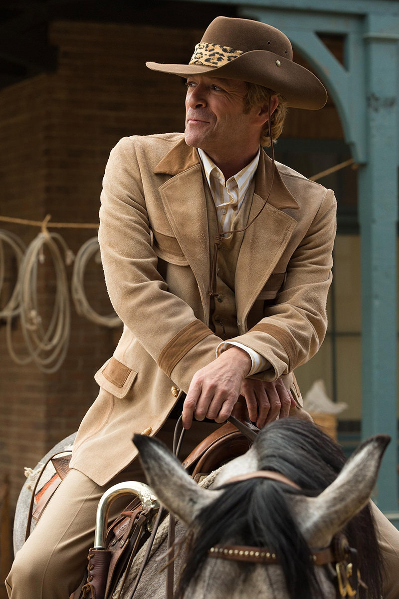 Luke Perry in Once Upon a Time in Hollywood on his horse dressed up in a Western suit complete with cowboy hat and leopard-print band.