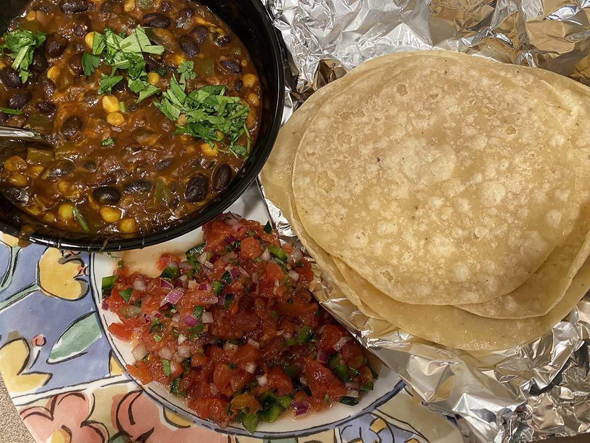 My dinner. It's a bowl of chili with a stack of corn tortillas and Salsa.