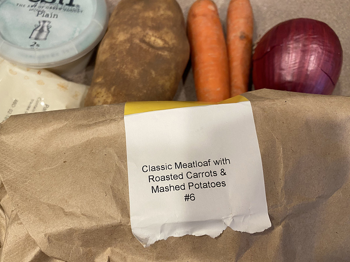 A label on an ingredients bag which says CLASSIC MEATLOAF WITH ROASTED CARROTS AND MASHED POTATOES.