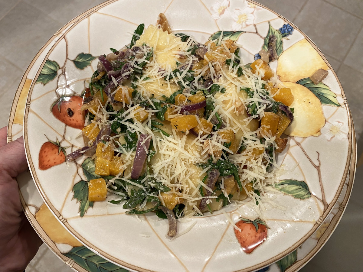 My dinner. It's a pretty bowl of halved cherry tomatoes in a salad with flatbread pizza that has onions and poblanos and melted cheese..