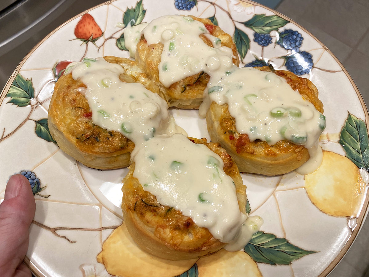 The pinwheels plated with the sauce on top.