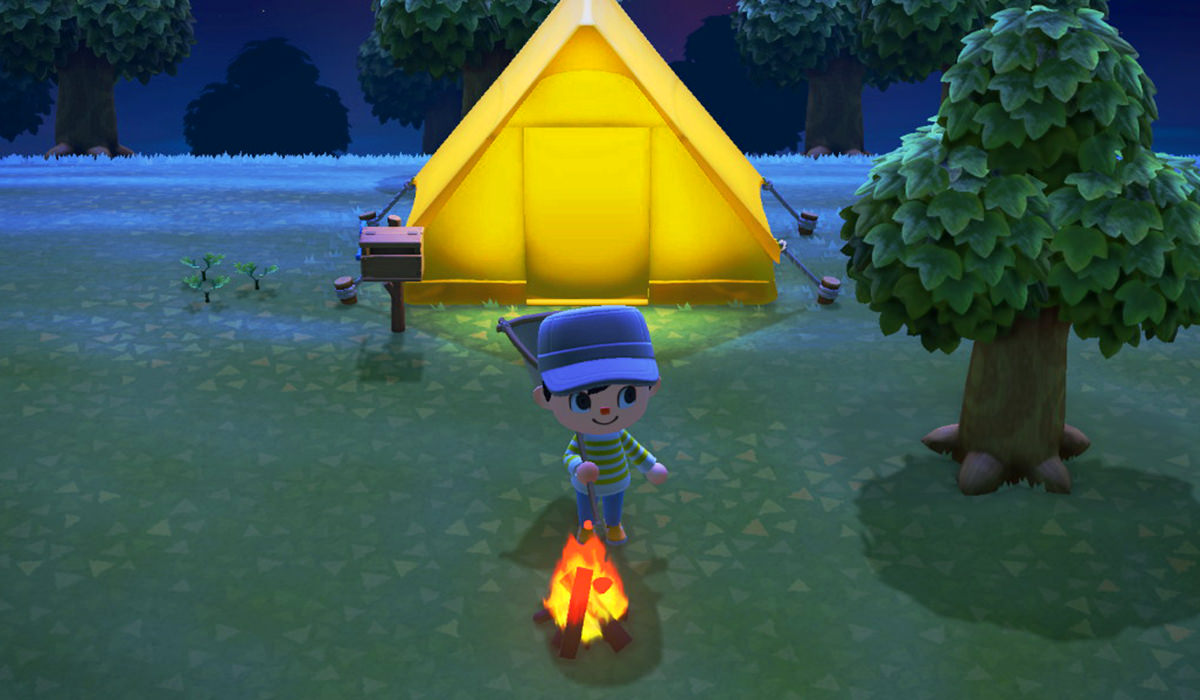 My character sitting by a campfire in front of my tent at night time.