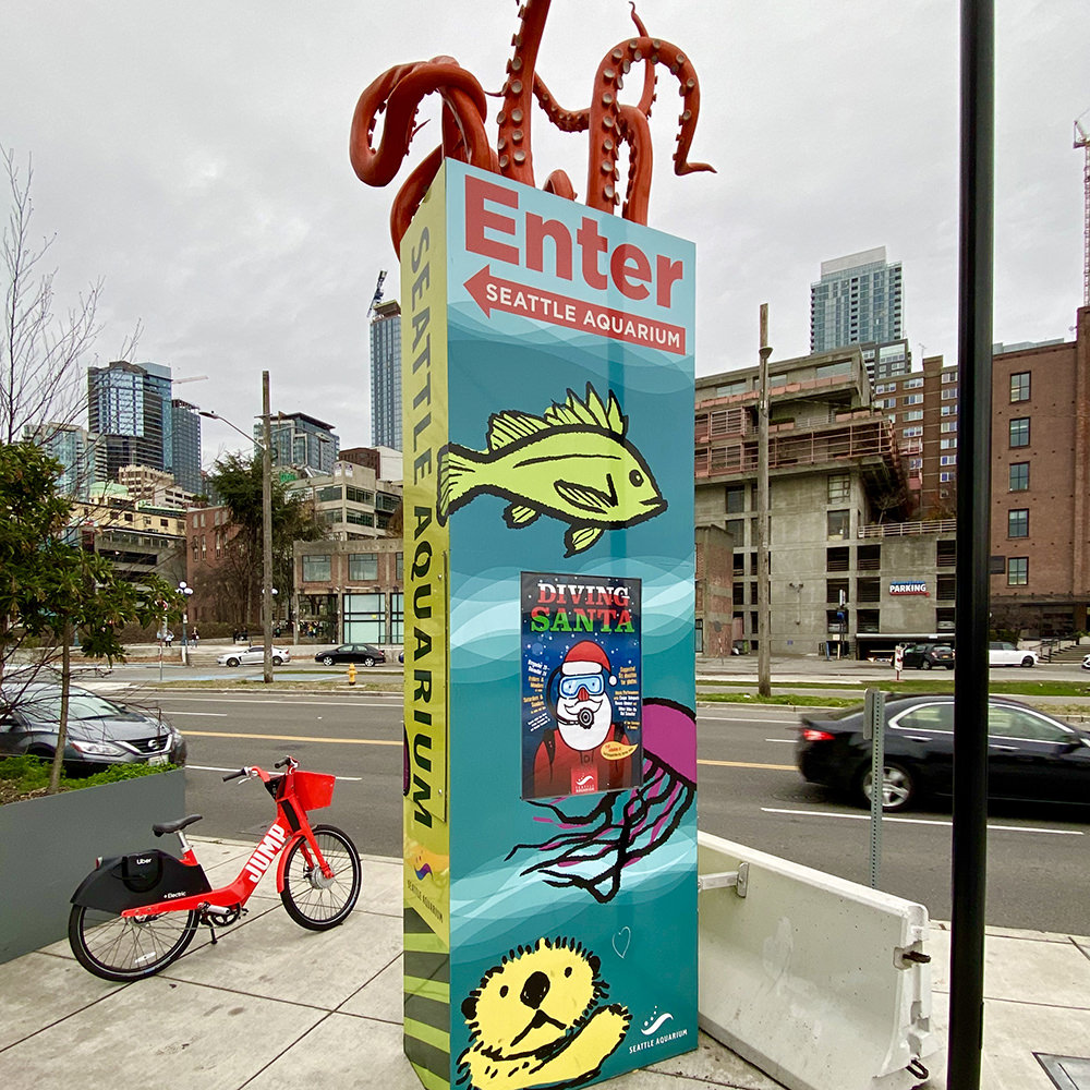 Sign to the Seattle Aquarium with tentacles coming out of the top.