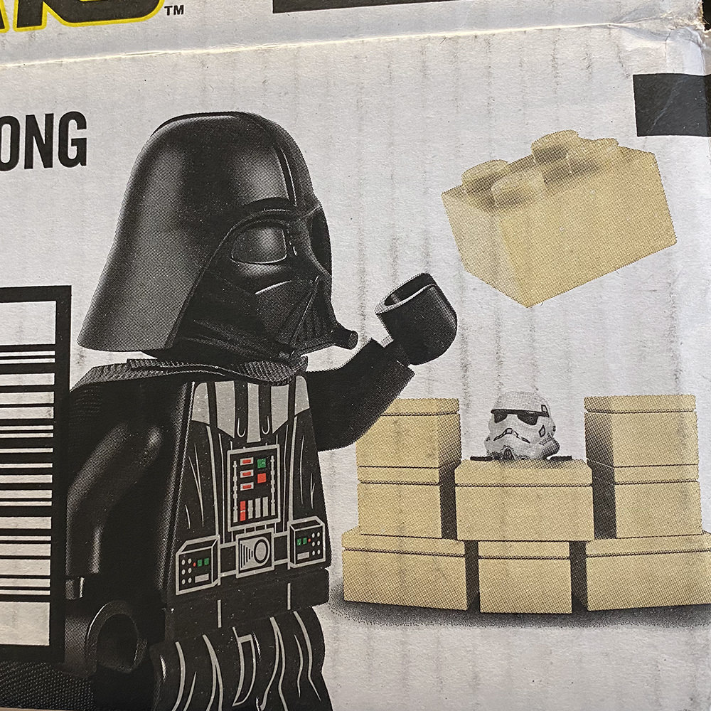 An Amazon box with LEGO Darth Vader has imprisoned the LEGO Stormtrooper in a jail cell made of the LEGO bricks!