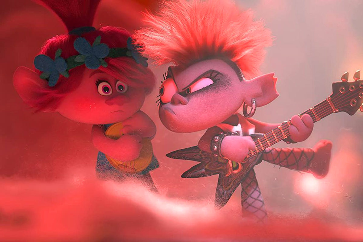 A still frame from Trolls: World Tour showing a mean punk troll with a guitar staring down a cute troll... or something like that... I honestly have no idea who is mean or who is good and honestly don't care.
