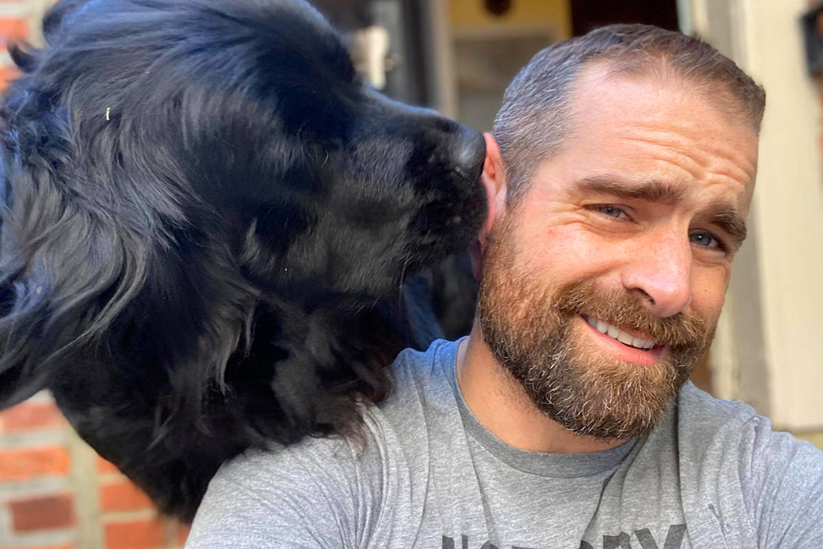 Brian Sims looking gorgeous and hanging out with his dog.