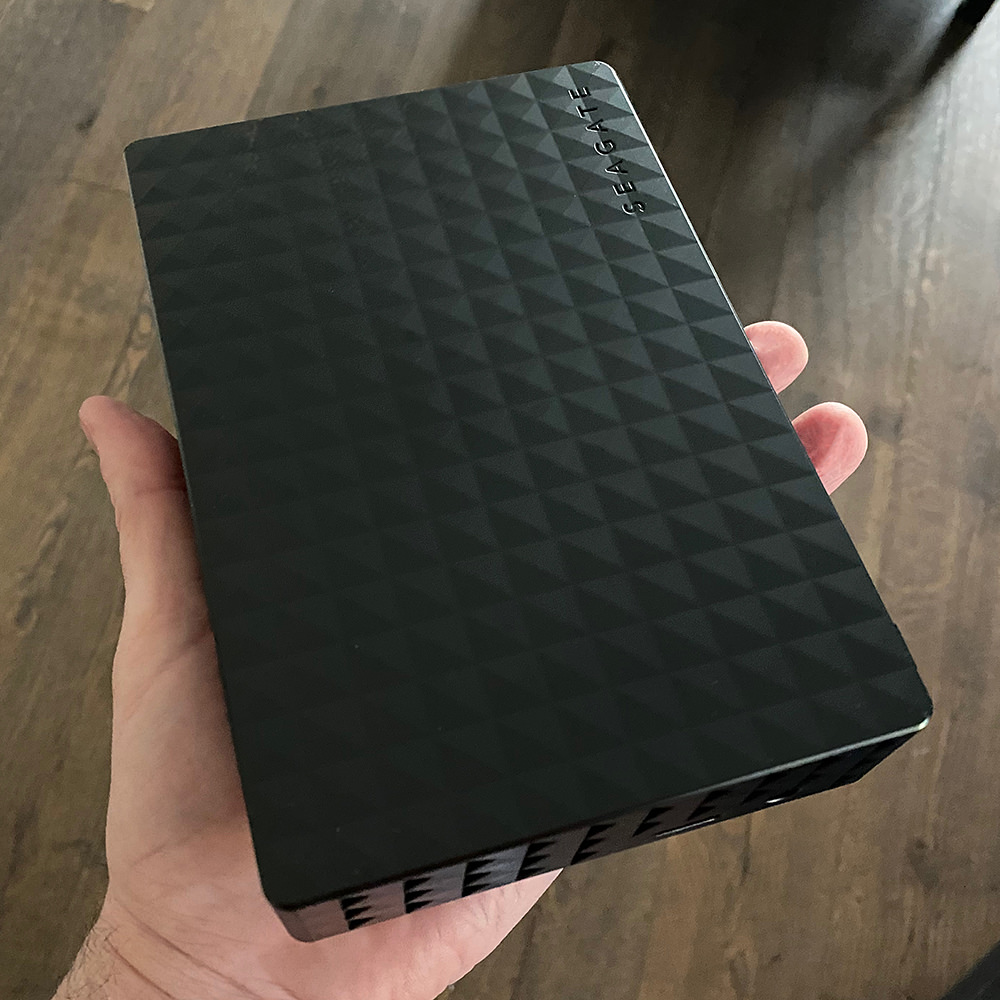 My hand holding a lovely new 14 TB drive.