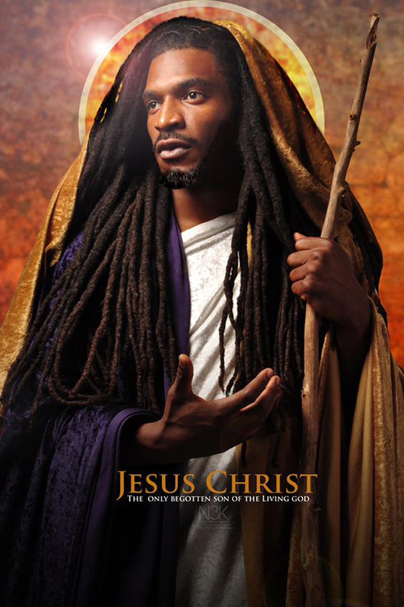 Black Jesus with long dreadlocks holding a wood branch as a staff with a halo behind his head as photographed by James Lewis.