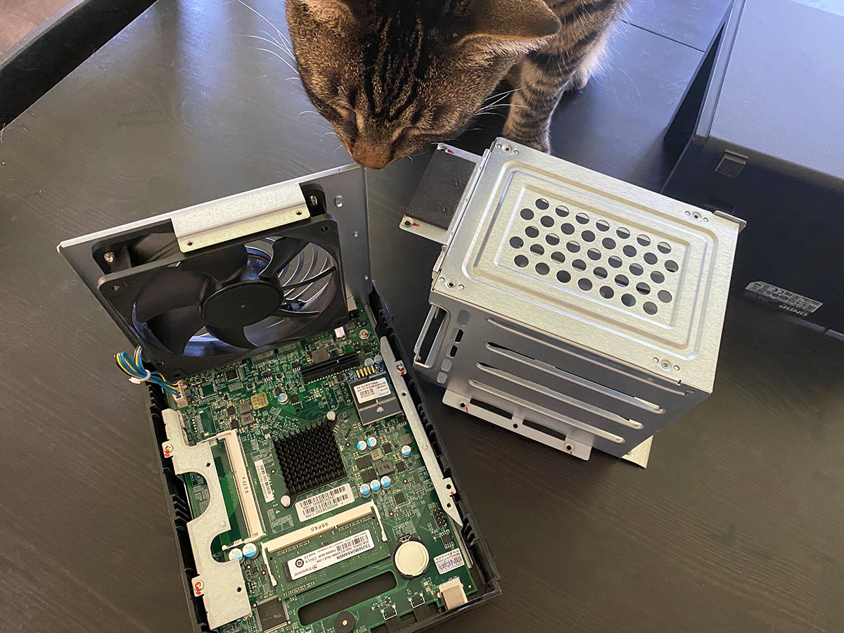 My cat Jake sniffing around at a QNAP TS-451+ NAS that's been opened up.