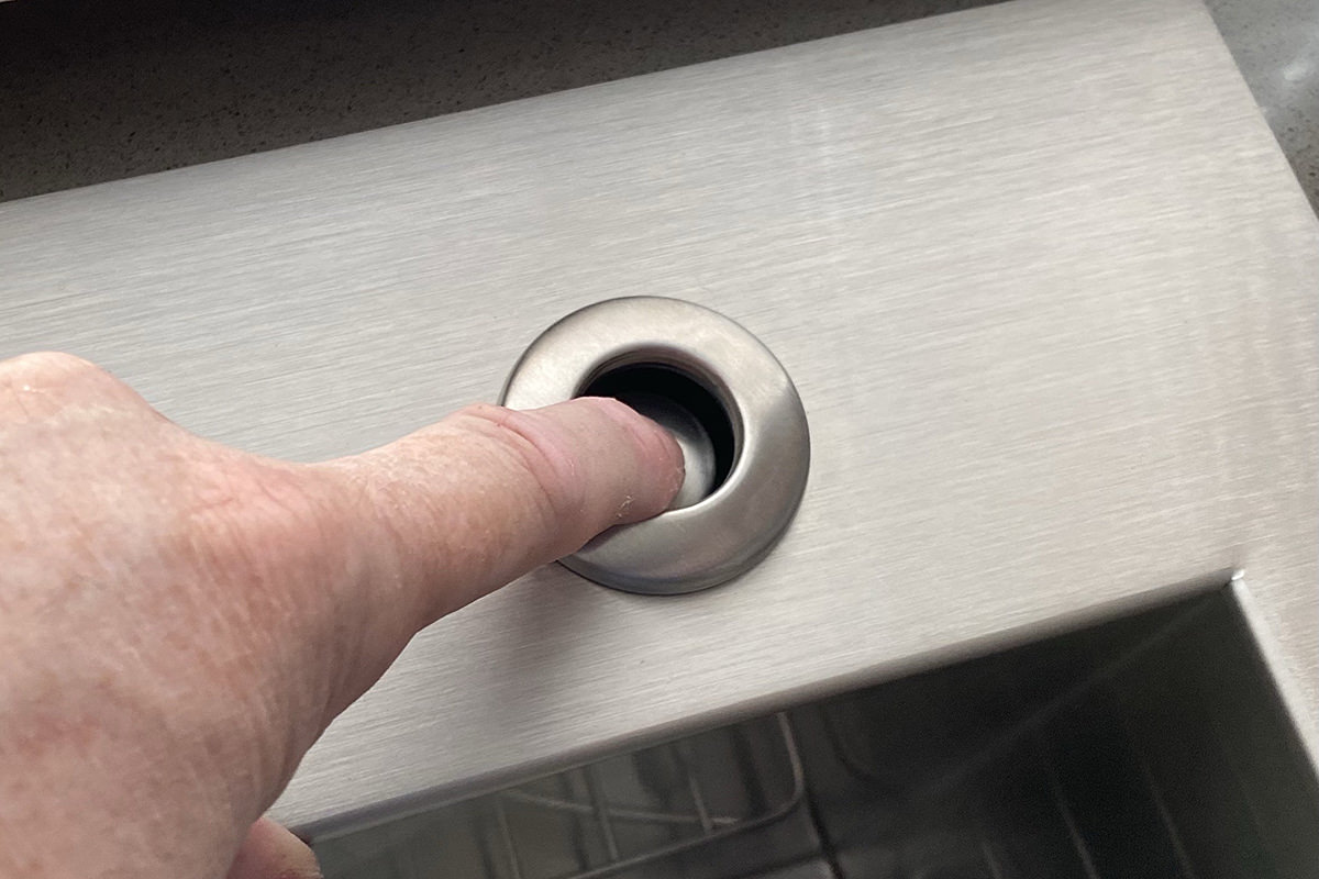 Pressing a button installed on my sink rim.